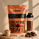 Bolsa de Creatine Protein Glorioso sabor cacao junto a shaker con batido de chocolate, proteína vegetal con creatina monohidrato y DigeZyme sobre pedestal de piedra en ambiente premium.